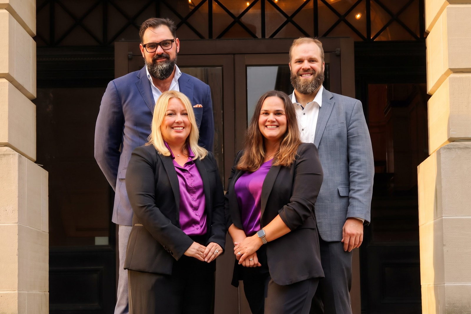 Tyler Wrezinski, Andrew Hall and the founding team at the door of the Bloomington office